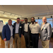 A group of men standing in a line for a photo.