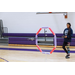 A kid flying a drone through a hoop.
