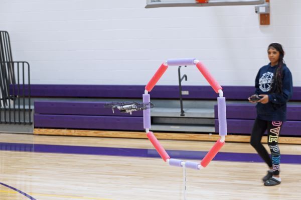 Aviation1.jpg A kid flying a drone through a hoop.