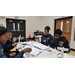 Four students building rockets at a table.