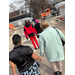 Individuals walking down a road to a bus.