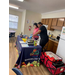 Two women cooking at a display table.
