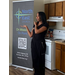 A woman speaking while standing next to a sign that says North East Church. On Mission, On Point. 