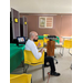 A man facing sideways sitting in a yellow chair.