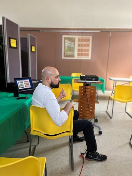 ProfessionalArt2.jpg A man facing sideways sitting in a yellow chair.