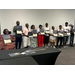  Ten ASCEND Program graduates standing in a line for a group photo with their awards. 