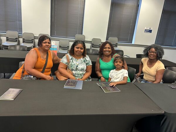 DUHANCASCENDProgram5.jpg Five women sitting together at a black table.