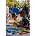  Children standing around a table reading books on display. 