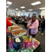  A woman standing in front of a buffet of food trays. 