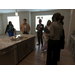  Individuals talking around a kitchen island. 