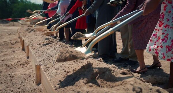 Several shovels lined up breaking ground on the Villages of Hayti community.
