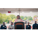  A woman standing behind a podium speaking to a crowd. 
