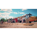  A wide shot of a group of individuals using shovels to break ground at the Villages of Hayti. 