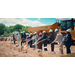  Individuals shoveling dirt to break ground at the Villages of Hayti. 